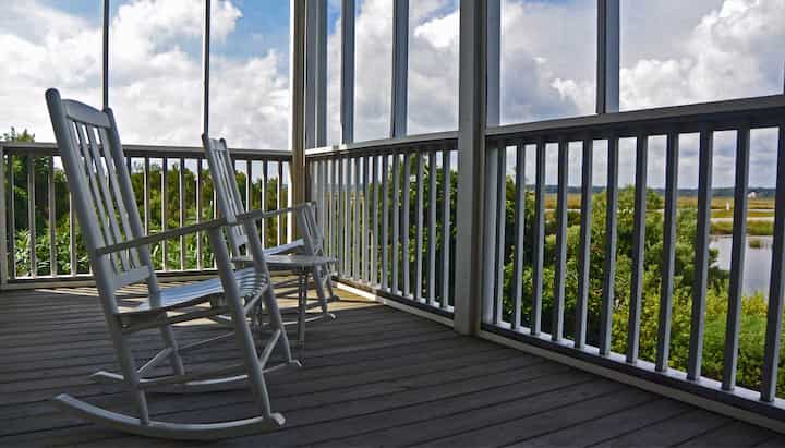 A comfortable deck screen porch with cozy seating in Lancaster, perfect for enjoying the outdoors while staying protected from bugs and pests.